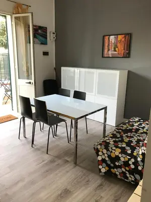 a dining room with a white table and chairs at Appartamento Trilocale Mondello in Mondello