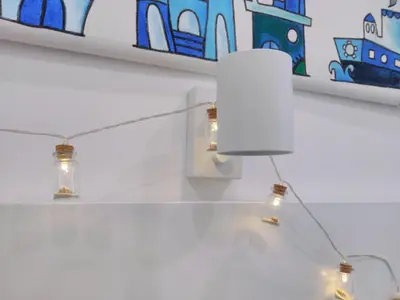 a light fixture with three lights on a wall at Casina Blu in Palermo