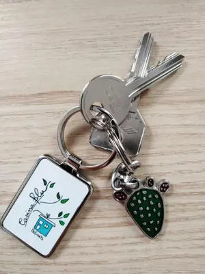 a key chain with a cell phone on a table at Casina Blu in Palermo