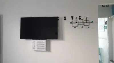 a flat screen tv hanging on a wall at Casina Blu in Palermo