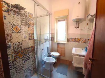 a bathroom with a shower and a toilet and a sink at La Casa Del Nonno in Monreale