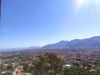 a view of a city with mountains in the background at La Casa Del Nonno in Monreale