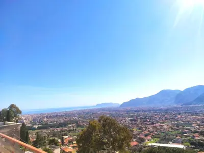 a view of a city with mountains in the background at La Casa Del Nonno in Monreale
