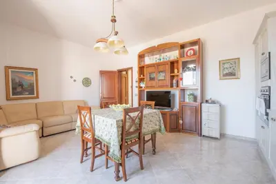 a living room with a table and a couch at A pochi passi dal mare in San Vito lo Capo
