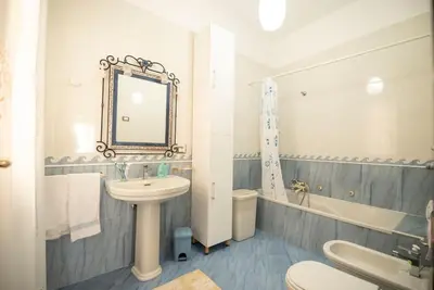 a bathroom with a sink and a mirror and a tub at A pochi passi dal mare in San Vito lo Capo