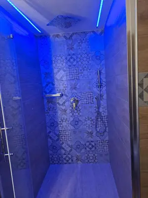 a bathroom with a shower with blue lighting at Colle del Re Sicily in Partinico