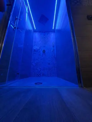 a dark room with a shower with blue lights at Colle del Re Sicily in Partinico