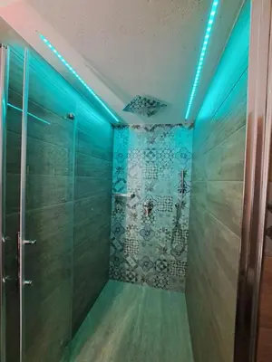 a walk in shower with blue lights in a room at Colle del Re Sicily in Partinico