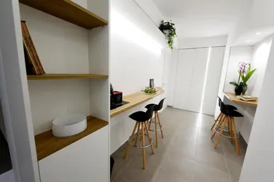 a stairway with white walls and white stairs with pink flowers at Blu in Blu Comfort rooms in Terrasini
