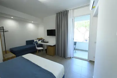 a bedroom with a large bed and a blue couch at Blu in Blu Comfort rooms in Terrasini