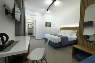 a bedroom with a bed and a desk with a chair at Blu in Blu Comfort rooms in Terrasini