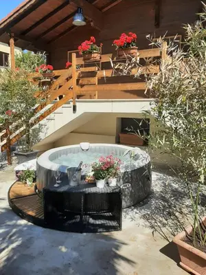 a table with chairs and a vase of flowers on a deck at villla chiazzese in Palermo