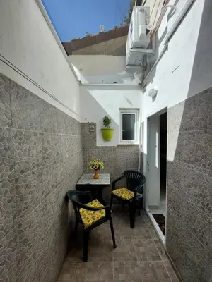 a small patio with two chairs and a table at Salsedine Apartment in Palermo