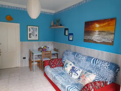 a living room with a couch and a table at Salsedine Apartment in Palermo