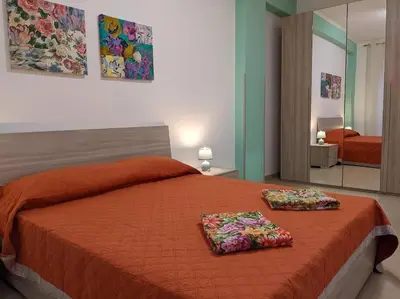 a bedroom with a bed with two pillows on it at CASA 3T a Isola a 15 min dal centro di Palermo in Isola delle Femmine