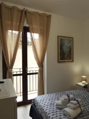 a bedroom with a bed with towels on it at A Casa di Eli Apartment in Palermo