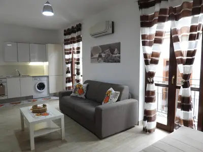 a living room with a couch and a table at A Casa di Eli Apartment in Palermo