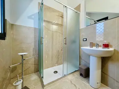 a bathroom with a sink and a shower at Magaggiari Reef in Cinisi