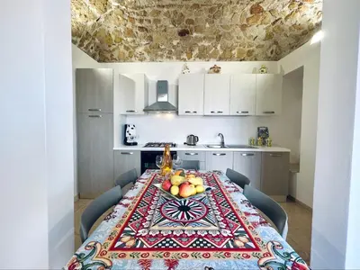 a kitchen with a table with fruit on it at Magaggiari Reef in Cinisi