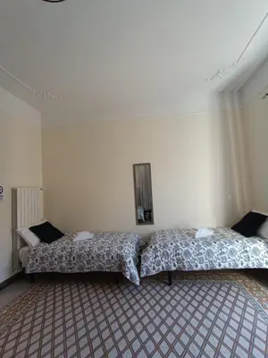 a bedroom with two beds in a room at Room Sixty One in Palermo