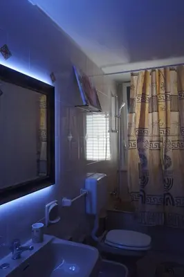 a bathroom with a toilet and a sink and a shower curtain at Casa di Vale in Palermo