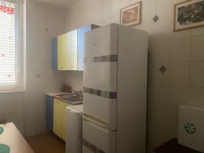 a white refrigerator in a kitchen with a sink at Casa di Vale in Palermo