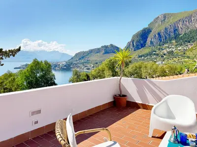 a balcony with a view of the water and mountains at Solemar Sicilia - Villa dei due Golfi in Santa Flavia