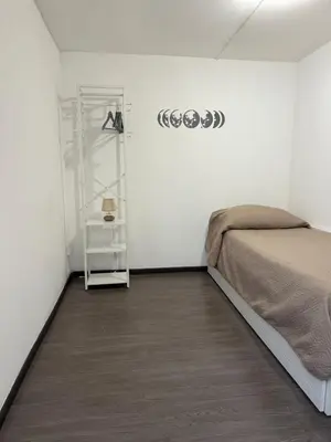 a bedroom with a bed and a shelf on a wall at Marea in Palermo