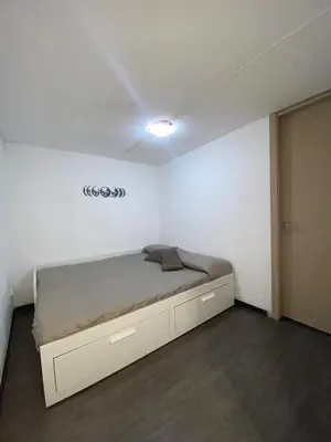 a bedroom with a bed in a white room at Marea in Palermo