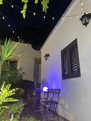 a patio with a table and lights in a house at Marea in Palermo