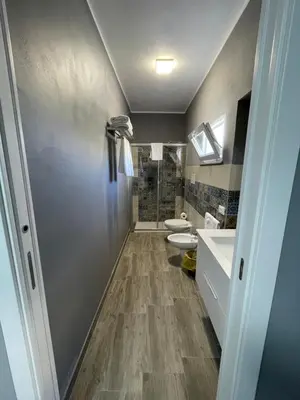 a bathroom with two sinks and two toilets at RESIDENCE GORDON in Carini
