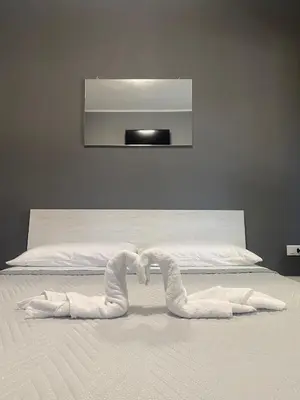 two swans made out of towels on a bed at RESIDENCE GORDON in Carini