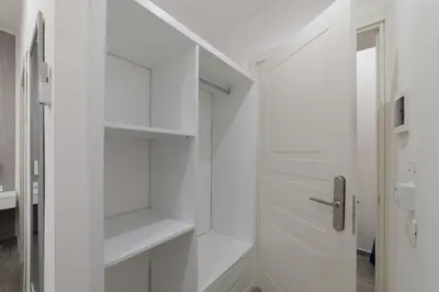 a white walk in closet with white shelves at Blanc Rooms in Palermo
