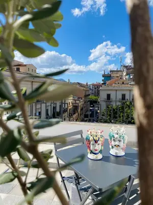 two ceramics sitting on a table on a balcony at Attico Belvedere in Palermo
