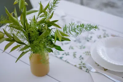 a vase with a plant sitting on a table at Nice home in Carini