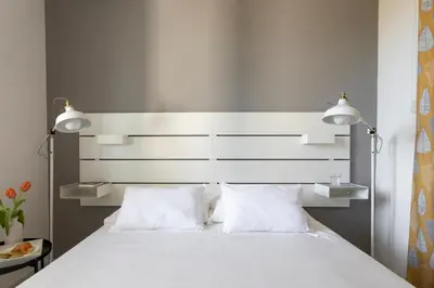 a bedroom with a white bed with two pillows at Nice home in Carini
