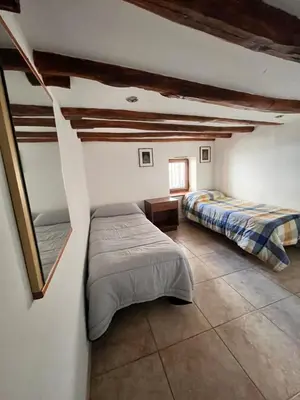 a bedroom with two beds and a window at House del Corso in Palermo