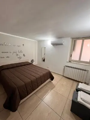 a bedroom with a large bed and a window at House del Corso in Palermo