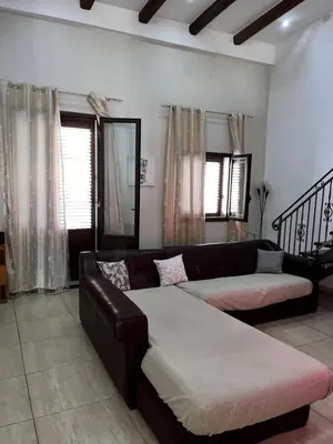 a living room with a leather couch at House del Corso in Palermo