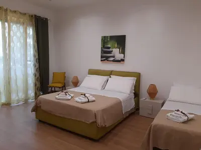 a bedroom with two beds with towels on them at PortoAmuri in Palermo