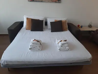 a large white bed with towels on top of it at PortoAmuri in Palermo