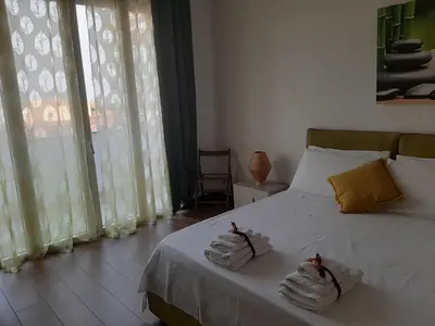 a bedroom with a bed with towels on it at PortoAmuri in Palermo