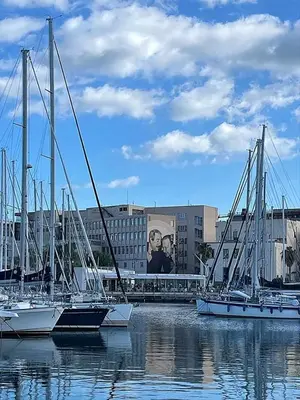 a group of boats docked in the water in a harbor at PortoAmuri in Palermo
