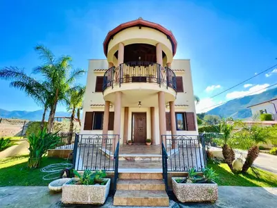 a large house with a balcony on top of it at La Cinisara in Carini