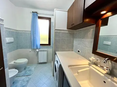 a bathroom with a sink and a toilet at La Cinisara in Carini