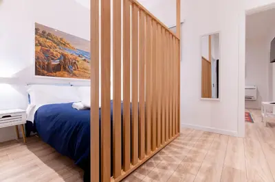 a bedroom with a bed and a wooden wall at SarAle Apartments in Palermo