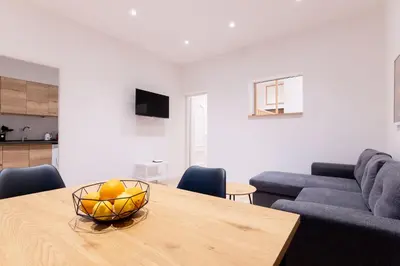 a living room with a table with a bowl of fruit on it at SarAle Apartments in Palermo