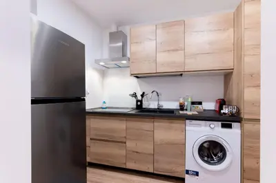 a kitchen with a refrigerator and a washing machine at SarAle Apartments in Palermo