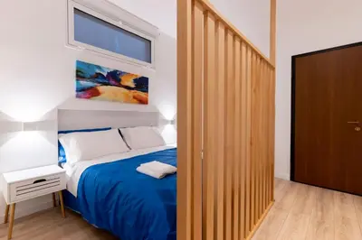 a bedroom with a blue bed and a window at SarAle Apartments in Palermo