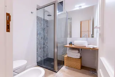 a bathroom with a shower and a toilet and a sink at SarAle Apartments in Palermo